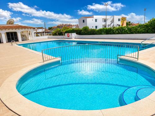 a large swimming pool with blue water at Cala Porter Soleil & Mer Collection in Cala en Porter