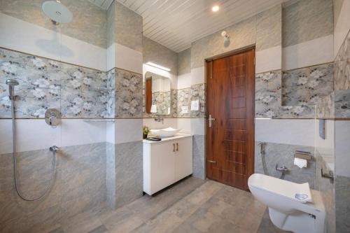 a bathroom with a shower and a sink and a toilet at A Mountains Suffer Hotel Kasauli Near Kasauli Hills Resort by Splendid Retreat Hotels - Family Groups - Balcony - Parking - Mountain View - River View - Forest Treks - Vacation - Memories in Kasauli