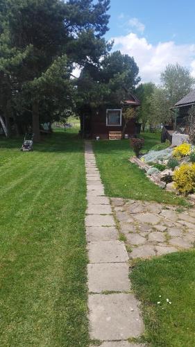 a stone path leading to a house in a yard at Chatka in Partizánska ľupča
