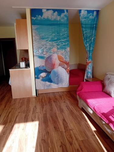 a living room with a large painting on the wall at Студио Ахелой in Aheloy