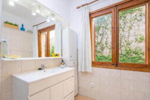 a bathroom with a sink and a mirror at Can Pons in Can Picafort