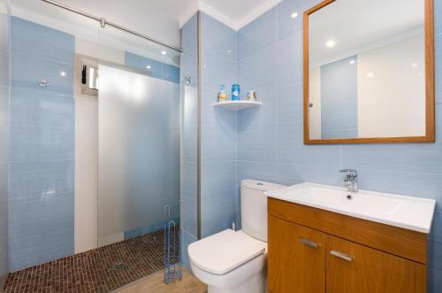 a bathroom with a toilet and a sink and a mirror at Can Vesses in Alcudia