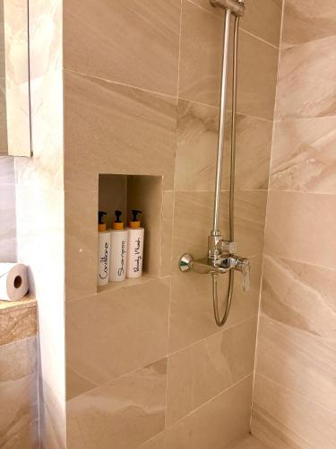 a bathroom with a shower with two shampoo bottles at Breezy Studio Aonang in Ao Nang Beach