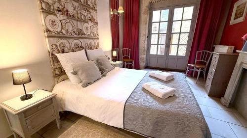 a bedroom with a large bed with two towels on it at Le Nid de la Loire - Centre historique - 4 pers - Classé 3 étoiles in Blois