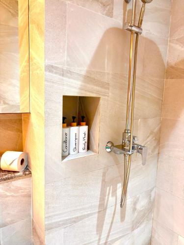 a bathroom with a shower with a bottle holder at Adventure Studio Aonang in Ao Nang Beach