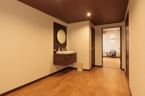 a bathroom with a sink and a mirror on the wall at 伊根の舟屋 樹 Funaya Inn Tatsuki , Ine in Kameshima