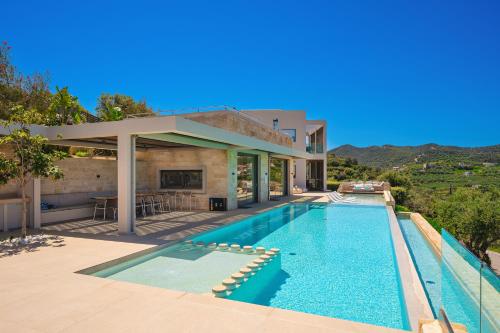 a swimming pool in the backyard of a house at Villa Reale - Wellness & Refined Living by etouri in Chania
