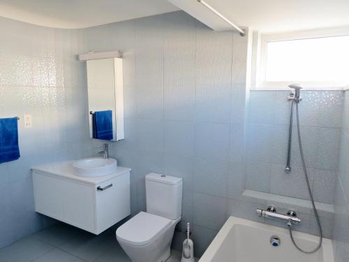 a bathroom with a toilet and a sink and a shower at Royal Sugar in Ayia Napa