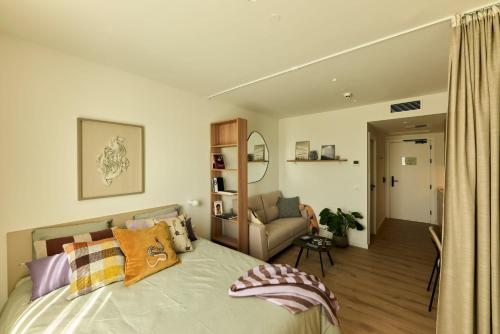 a bedroom with a bed and a living room at Be Casa Sant Cugat in Sant Cugat del Vallès
