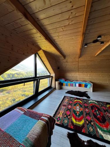 a room with a bed and a large window at SoTA SKI in Pilipets