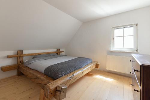 ein Schlafzimmer mit einem Holzbett und einem Fenster in der Unterkunft Peace Point in Velike Lašče