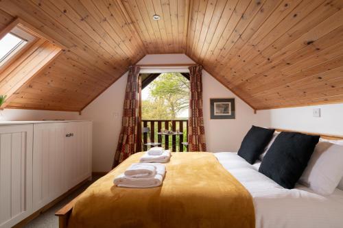 a bedroom with a bed with towels on it at E40 - Kiberick in Truro