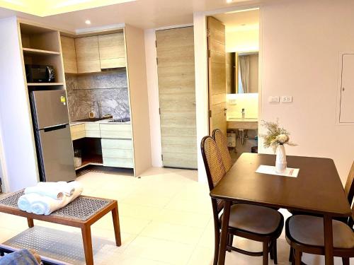a kitchen and dining room with a table and a dining room at Breezy Condo in Aonang in Ao Nang Beach