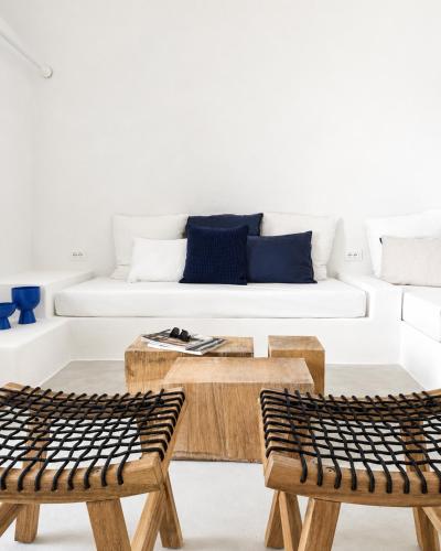 a living room with wooden tables and a white couch at Maridea - Villa Zagara in Ponza
