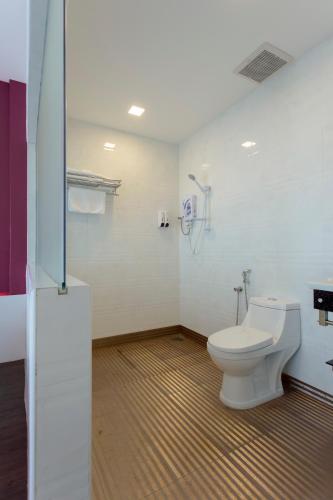 a bathroom with a white toilet in a room at Aloha Hotel SDN BHD in Pontian Kecil