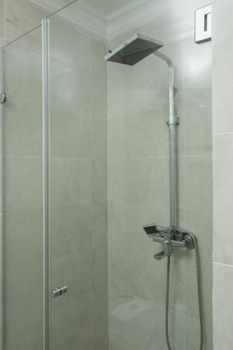 a shower in a bathroom with a glass door at Таугуль in Zhezdi
