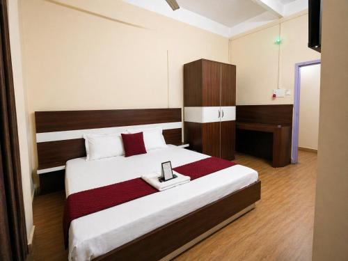 a bedroom with a large bed with a tray on it at Whitestone Inn in Guwahati