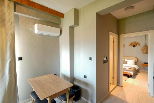 a room with a table and a bed at Alp Suites Mandalin in Akyaka