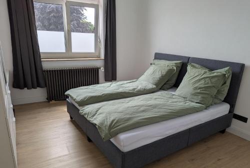 a bed sitting in a room with a window at Ferienwohnung Altstadt Lemgo in Lemgo