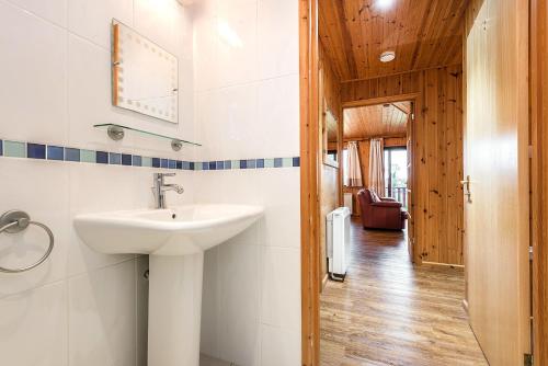 a bathroom with a sink and a hallway at E29 -Lawnside in Truro