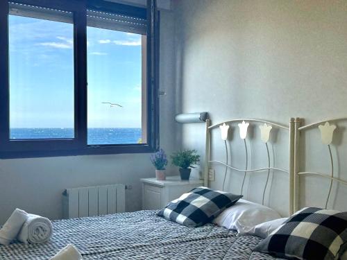 a bedroom with a bed with a view of the ocean at La Caseta - 5907 in Isla