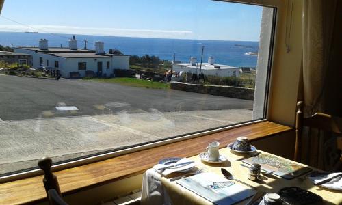 a window with a table and a view of a street at Achill West Coast House in Dooagh