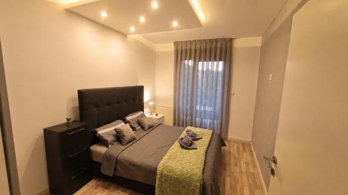 a bedroom with a large bed and a window at Luxury Apartment Paraćin - River View in Paraćin
