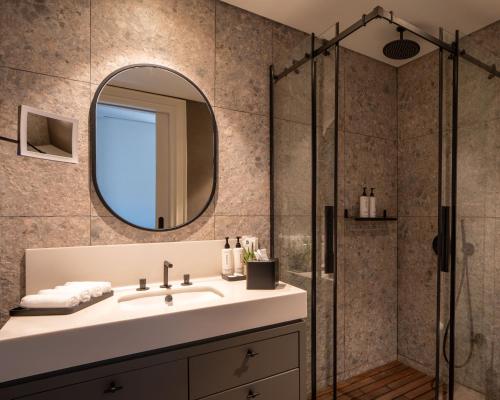 a bathroom with a sink and a shower at Hovagimyan Hotel and Suites in Istanbul