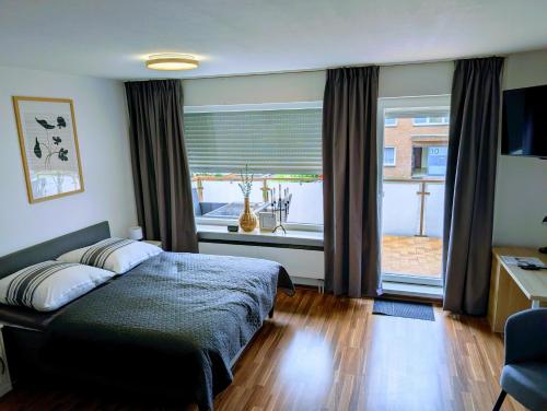 a bedroom with a bed and a large window at Apartment37671 in Höxter