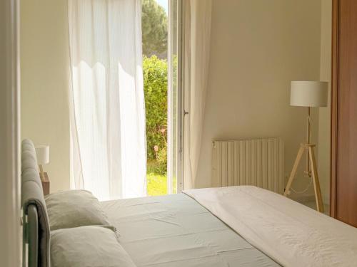 a bedroom with a bed and a large window at Casa di Leo - HelloElba in Portoferraio