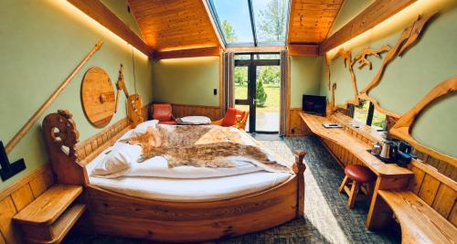 a bedroom with a large wooden bed and a desk at Gudvangen Fjordtell in Gudvangen