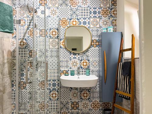 a bathroom with a sink and a mirror at Casa di Leo - HelloElba in Portoferraio