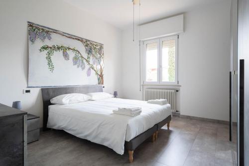 a bedroom with a bed with a painting on the wall at Villa Livia in Toscolano Maderno