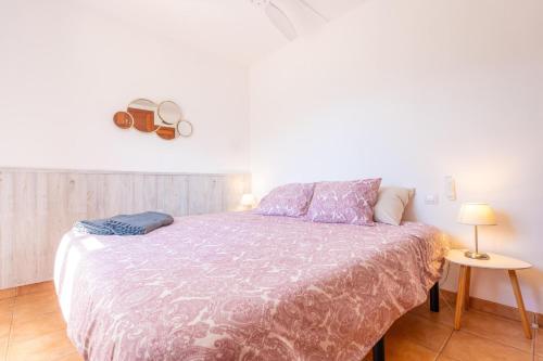 a bedroom with a bed and a table with a lamp at Son Bou in Sóller
