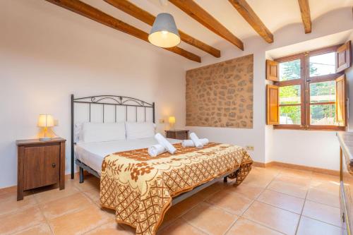 a bedroom with a large bed in a room at Can Raia in Sóller
