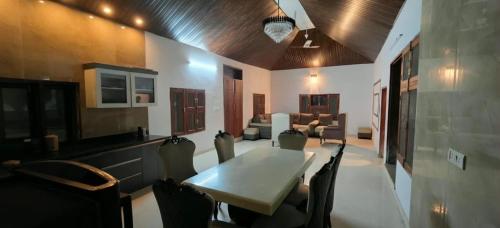 a living room with a table and chairs and a couch at Party Place with pool in Ballabgarh