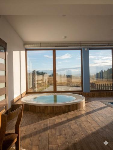 a large room with a large window with a hot tub at Hotel Góralski Raj in Nowy Targ