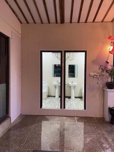 a bathroom with two sinks and two mirrors at Elephant homestay in Sapa