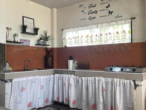 a kitchen with a sink and a counter top at Pine's View Casa Isabel Villa Staycation - Marilog, Davao City in Kayagan