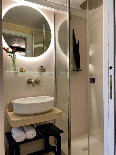 a bathroom with a sink and a shower at Domus Settecento in Putignano