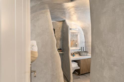 a bathroom with a sink and a mirror in a room at Just Blue in Oia