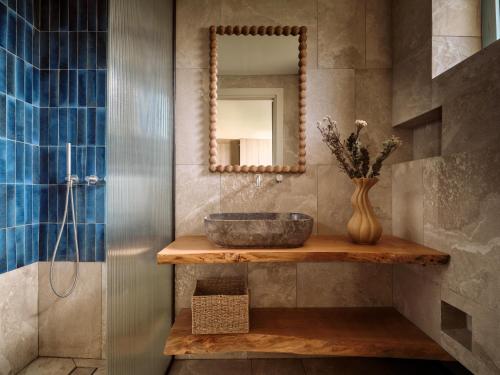 ein Badezimmer mit Waschbecken und Spiegel in der Unterkunft Pierros Hotel in Laganas