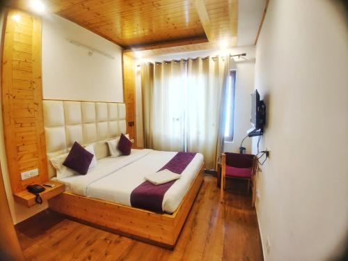 a bedroom with a bed and a television in it at Hans Cottage in Shimla