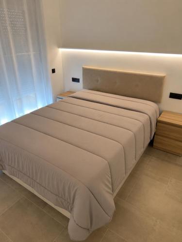 a bedroom with a large bed with a white bedspread at Residencial Lleida in Lleida