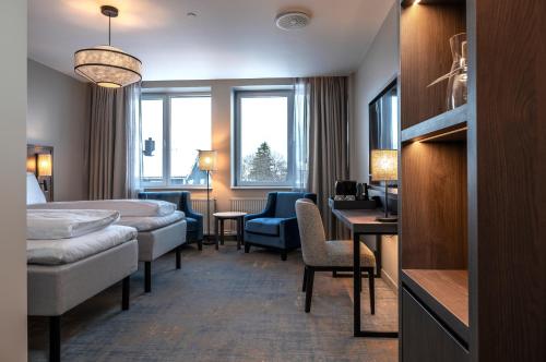 a hotel room with a bed and a desk at Thon Hotel Andrikken in Andenes