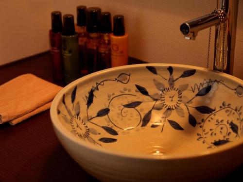 a bathroom sink with a flower pattern on it at Hanano Koyado Jyu-bei in Toba