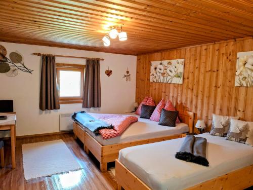 a room with two beds and a couch in it at Lampererhof in Sankt Johann in Tirol