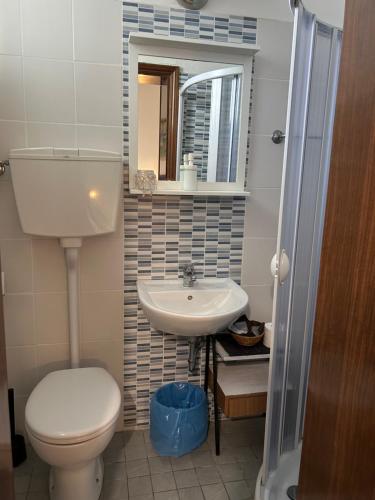 a small bathroom with a toilet and a sink at Bed and Breakfast Villa Giovanna in Rimini