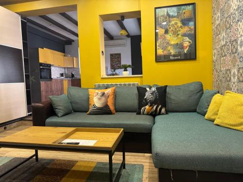 a living room with a couch and a table at Trakia Street Apartment in Plovdiv