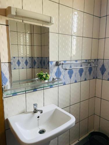 a bathroom with a sink and a mirror at HD Luxury Apparts in Yaoundé